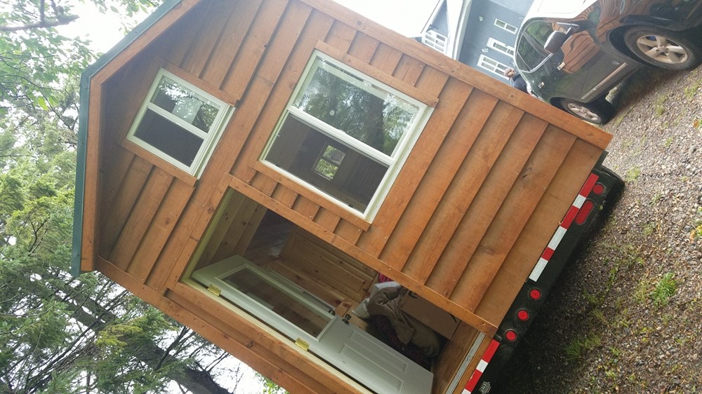 Tiny amish built wooden cabin on wheels